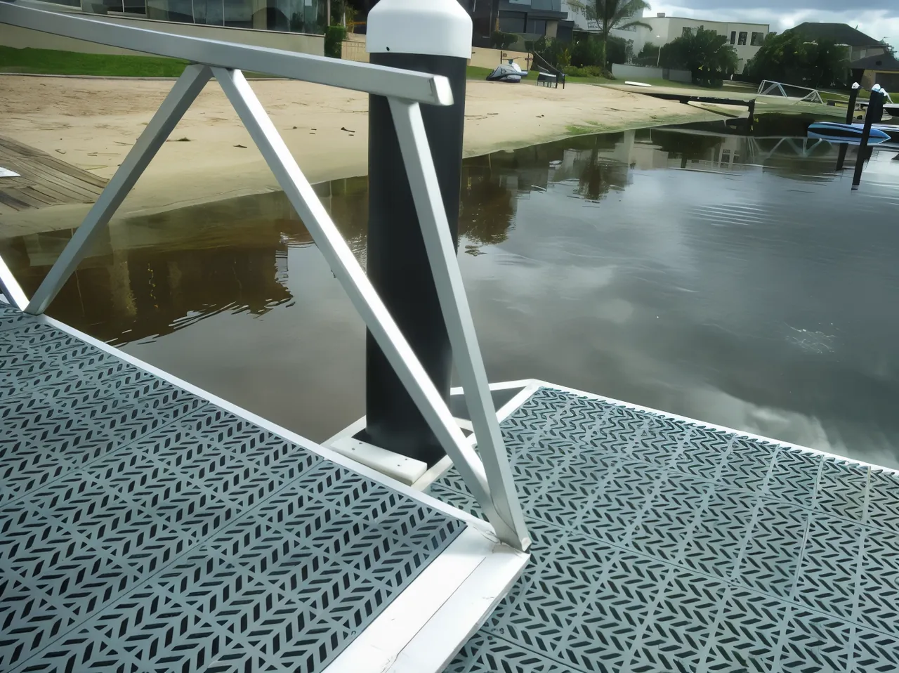 A pontoon decked with grey PolyGrid panels in a canal estate